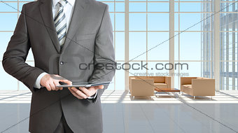 Businessman with tablet in office building
