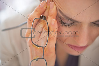 Closeup on stressed business woman with eyeglasses