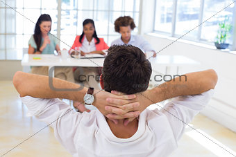 Businessman relaxed with hands behind head