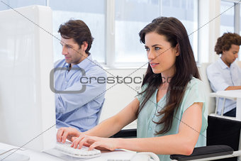 Attractive woman in wheelchair working hard on computer