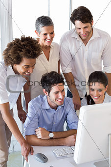 Attractive business people working hard on computer