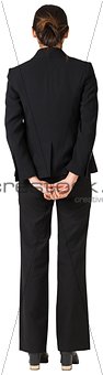 Businesswoman standing with hands behind back