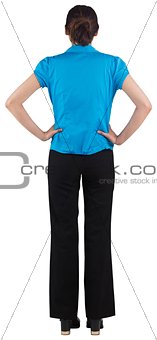 Young businesswoman standing with hands on hips