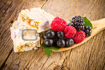 Muesli bars with fresh berries in spoon