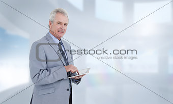 Composite image of side view of mature tradesman with tablet computer