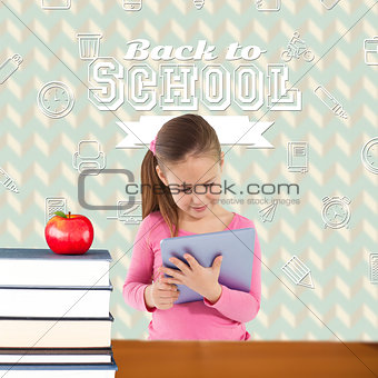 Composite image of cute girl using tablet
