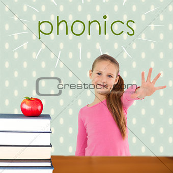 Phonics against red apple on pile of books