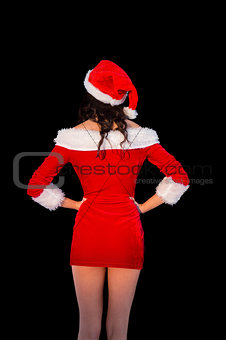 Pretty brunette in santa outfit posing with hands on hips