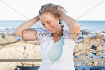 Casual woman smiling by the sea