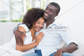 Attractive couple cuddling on the couch