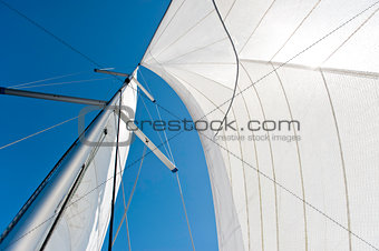 Sails and mast over blue sky background