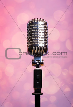 Professional vintage microphone over abstract background