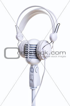 White microphone and headphones over white background