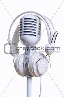 White microphone and headphones over white background