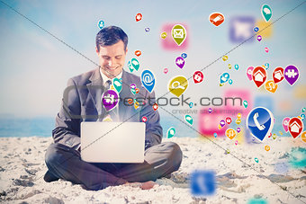 Composite image of young businessman with legs crossed typing on his laptop
