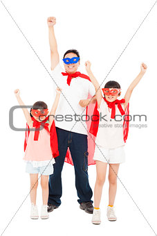 Father and daughters making a superhero pose with red cape