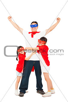 superhero daughters hug father waist. isolated on white 