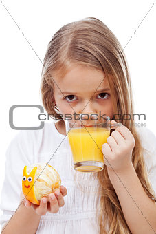 Little girl with fresh orange juice holding snail made of orange