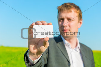businessman showing blank business card