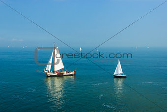 Seascape with big and small sailboats 