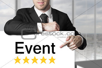 businessman pointing on sign event golden stars