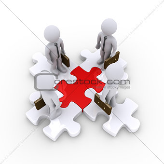 Businessmen on connected puzzle pieces