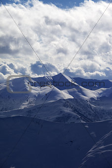 Evening sunlight mountain with clouds and silhouette of paraglid