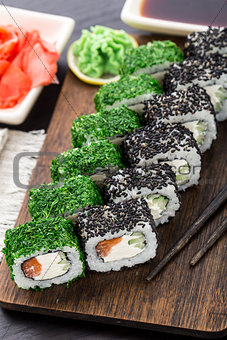 Sushi roll covered with dill and sesame