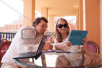 Young couple relaxing over coffee on a balcony