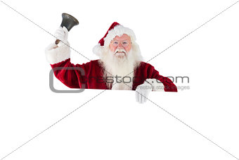 Santa holds a sign and rings his bell