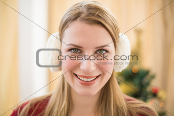 Portrait of a smiling blonde wearing earmuffs