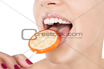 Enjoying. Young girl licking lollipop.