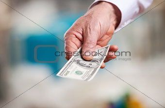 Hand with money against blurred background