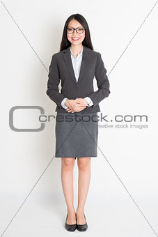 Full body smiling Asian business woman 