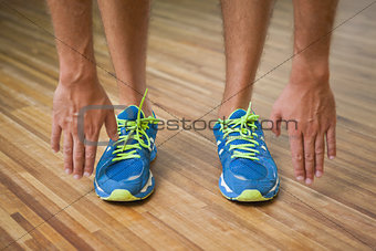 Low section of man in sports shoes in fitness studio