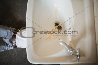 Plumber fixing the sink in a bathroom