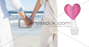 Composite image of couple on the beach looking out to sea holding hands