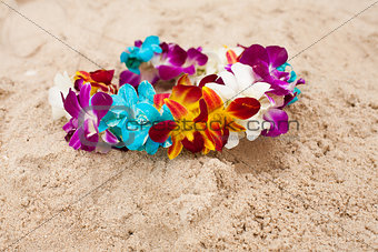 Colorful bright flower diadem on the sand