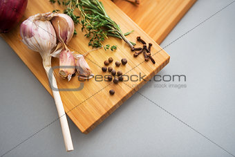 Closeup on pepper garlic and rosmarinus on cutting board