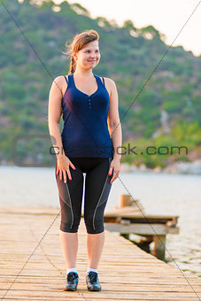 happy young girl on a wooden pier