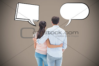 Composite image of attractive young couple standing with arms around