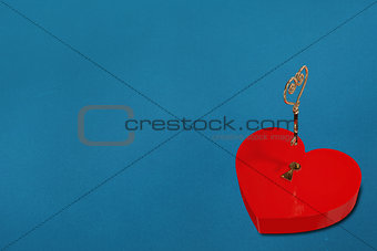 Bright red heart shaped lock with key