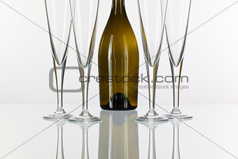 Four  champagne glasses on a glass table