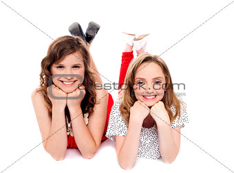 Girls posing with hands on chin. Lying on floor