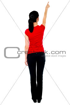 Back pose of woman in casuals pointing away
