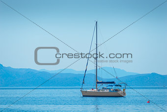 lone sailing yacht drifting in the sea