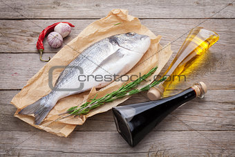 Fresh dorado fish cooking with spices and condiments