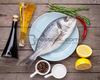 Fresh dorado fish cooking with spices and condiments