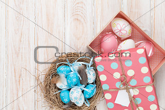 Easter with blue and white eggs in nest and gift box