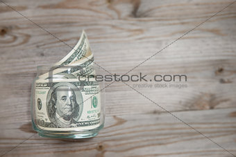 Dollars in money jar.